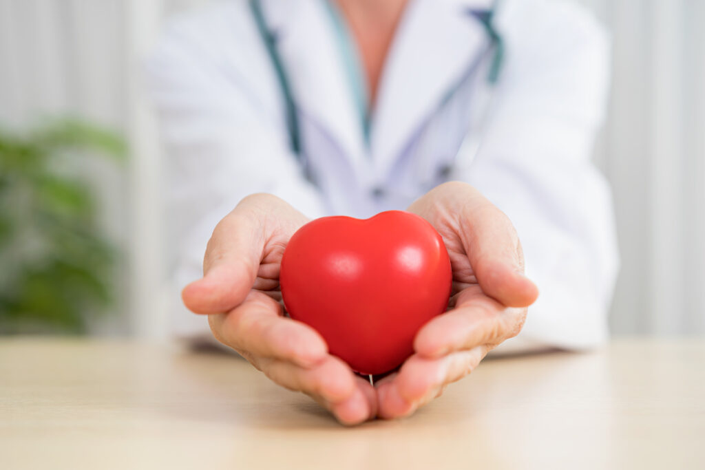 Health practitioner holding a heart
