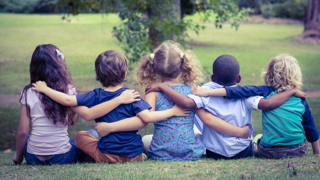 Group of children sitting together in a park