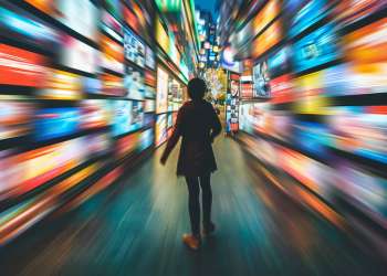 AI generated image - person standing with advertising blurring past them