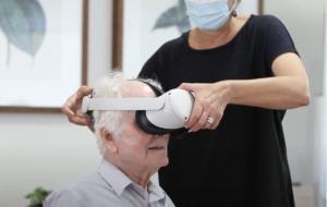 Older male having VR headset fitted