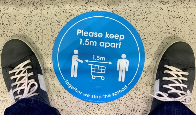 Social distancing sign on a footpath
