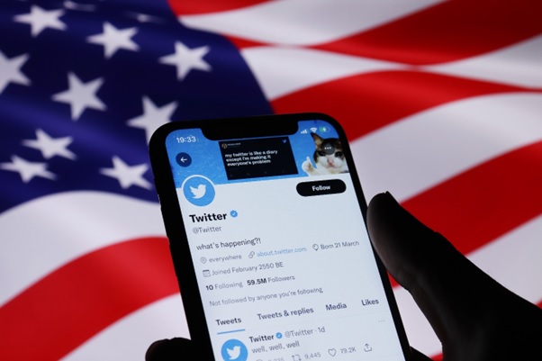 Twitter on a mobile and a US flag