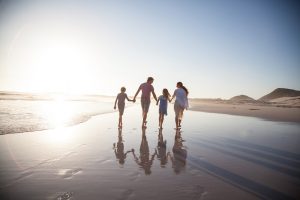 familiy walking together on a beach