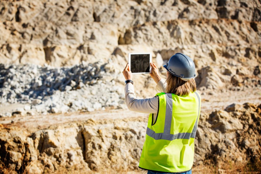 Woman with iPad in mining environment