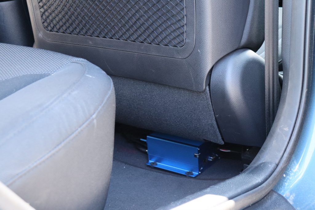 Image of in-vehicle box installed under a front seat in a vehicle