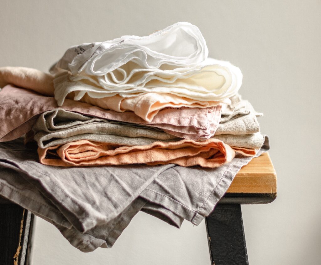 pile of linen napkins on a wooden stool