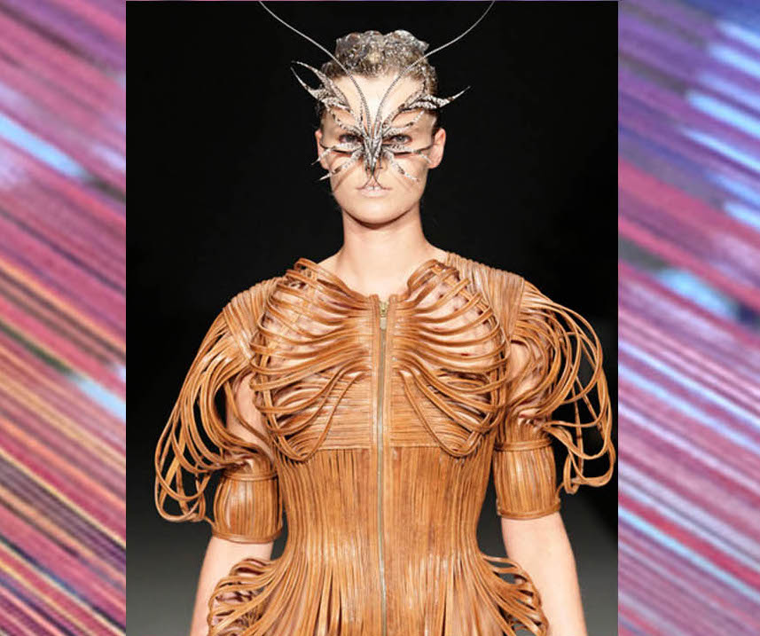 Model wearing crafted garment and moth like mask